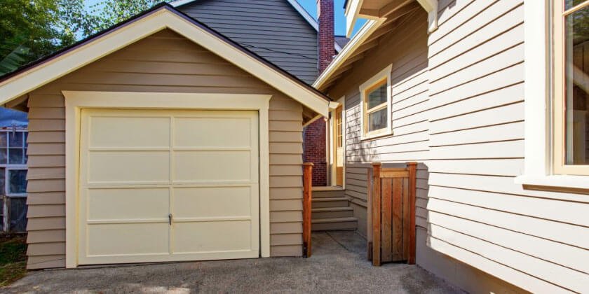 Detached garage next to a house with beige siding in Malden, CA.