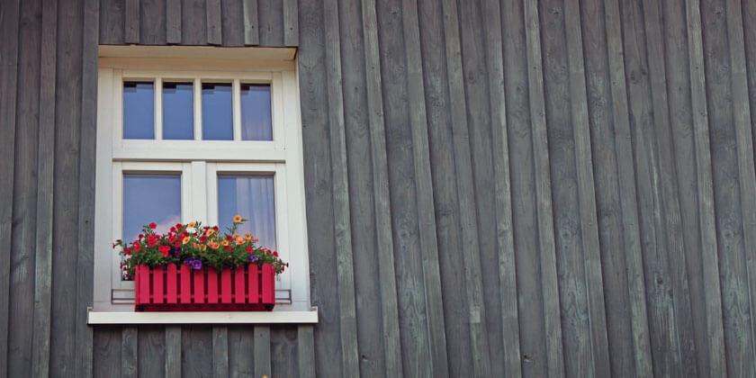 Window with flower box on a wooden wall facade, installed by a general contractor in Malden, CA.
